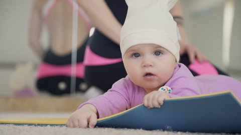 Small Child Lies On Gym Stock Footage