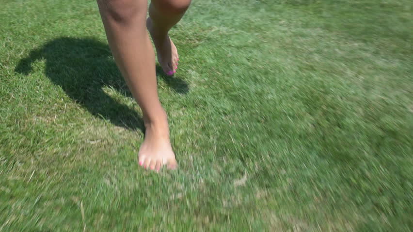 Childrens Barefoot Legs Walks On Summer Green Grass Bare Feet Of A