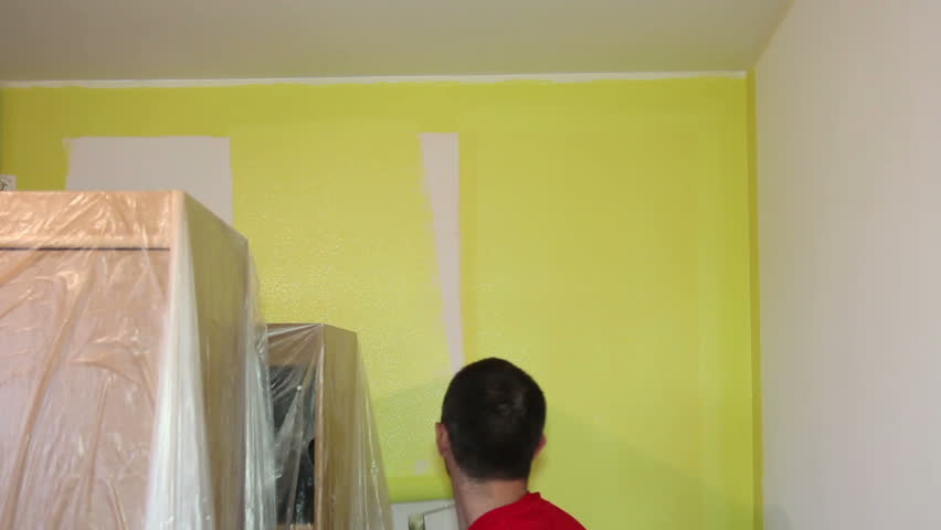 Man Painting A Room Decorator Stock Footage Video 100 Royalty Man Painting A Room Decorator Using Long Roller To Paint Wall In Yellow Hd1080p