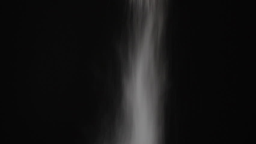 FX Steady Dust Snow Particles Fall Against Black Background. A Steady