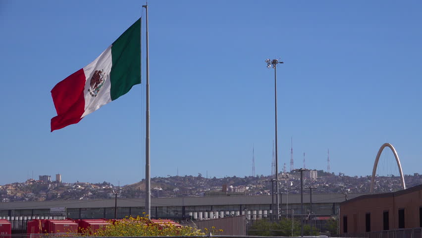 The Flag Of Mexico Flying High Above Tijuana Mexico At The US Border ...