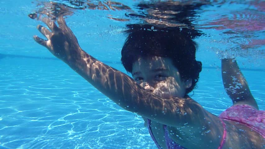 Boy Teen In Goggles Swims And Jerks Feet Under Water In Pool Stock