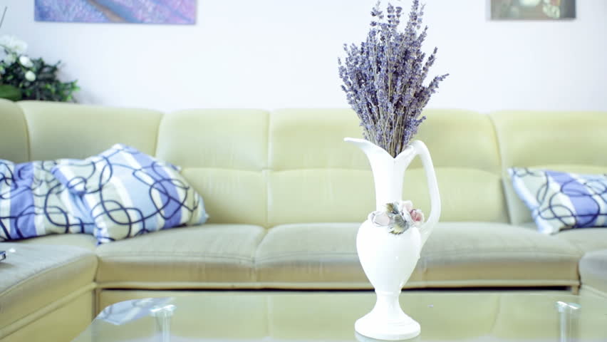 Living Room Vase vase of lavender flower on the table in living room, with sofa in Living Room Vase vase of lavender flower on the table in living room, with sofa in