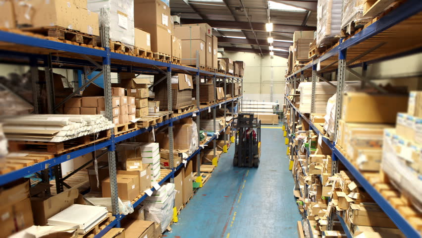 Time lapse of a busy group of workers in a warehouse or factory preparing goods for dispatch.