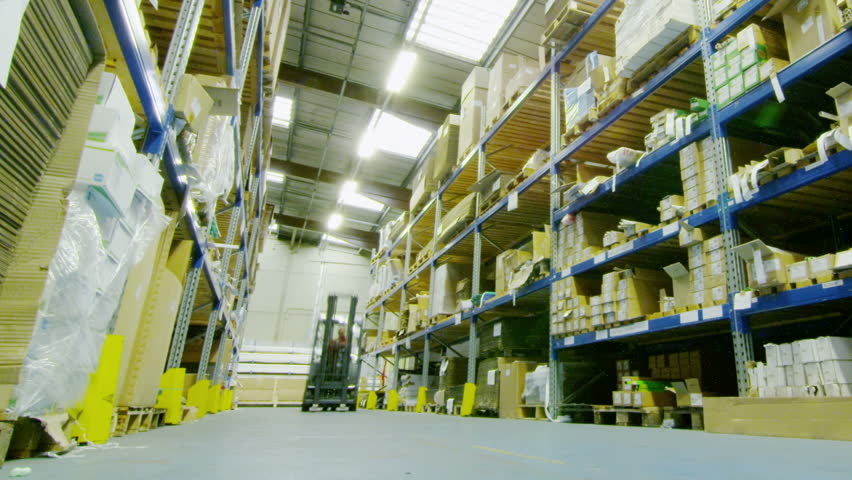 Time lapse of a busy group of workers in a warehouse or factory preparing goods for dispatch.