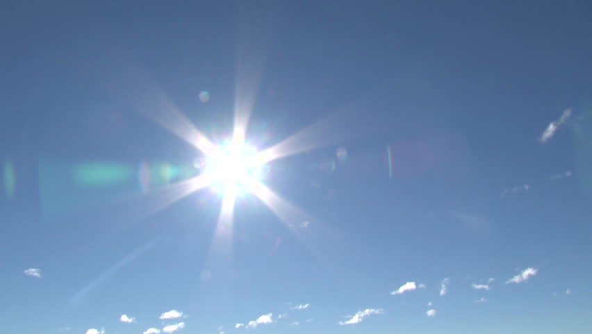 Blue sky day with bright sun shining bright, zoom in and pan.