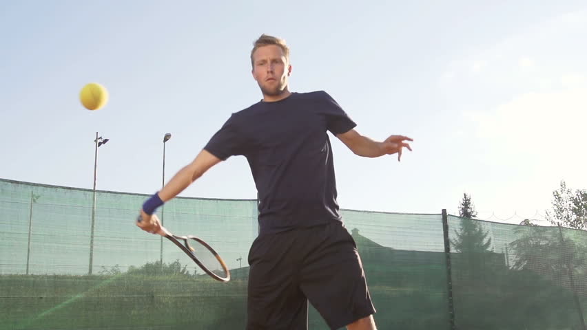 Slow Motion Shot Of A Professional Tennis Player Hitting Forehand With Tennis