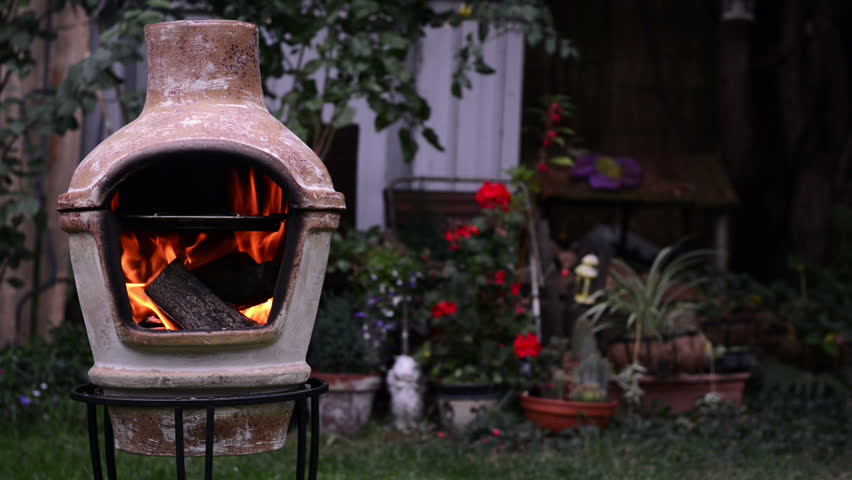 Hd00 25log Fire In Terracotta Clay Chimney At The Back Garden On