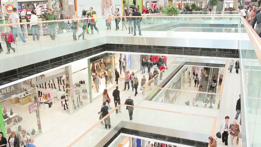Slightly defocused crowd of walking people in the newly opened shopping mall