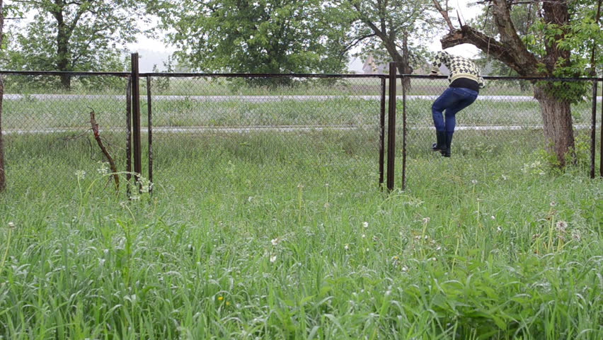 Jump over the fence. Climb over the fence. крокодил лезет через забор. thief climbing over the fence.