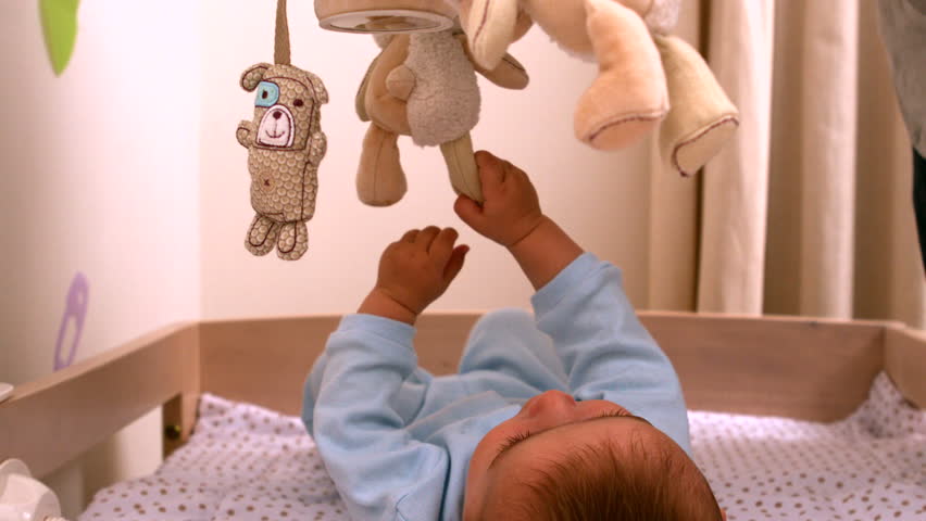 Baby Playing With Mobile In His Crib In Slow Motion