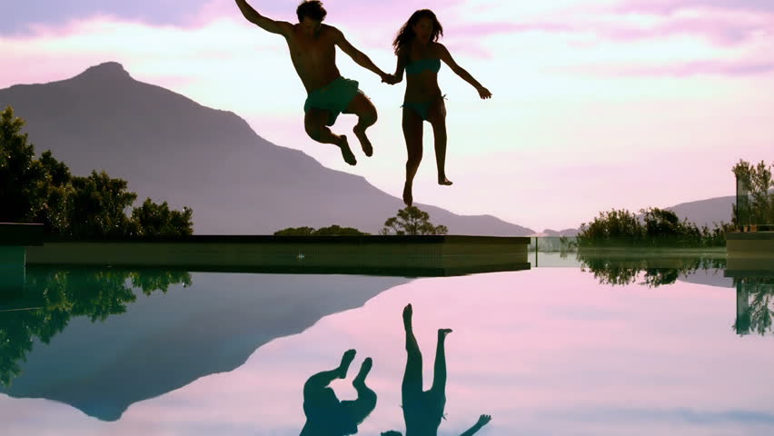 Couple jumping off cliff Couple jumping off cliff