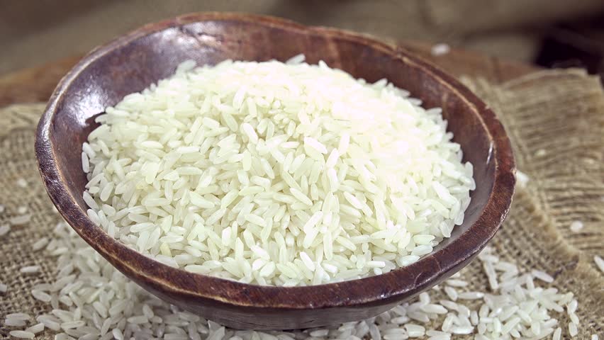 Pouring Rice In Wood Plate Closeup On Black Background Stock Footage ...